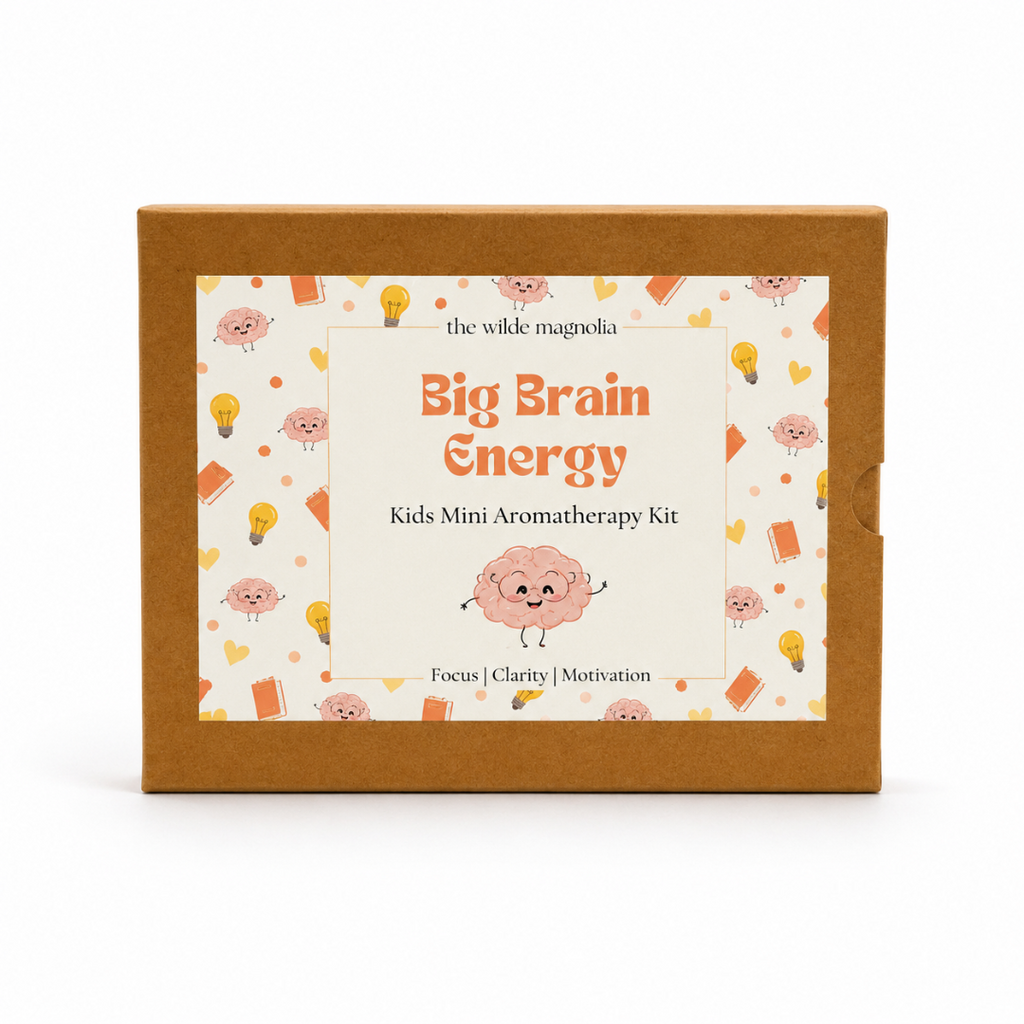 A rectangle kraft brown cardboard box for 'the wilde magnolia Big Brain Energy Kids Mini Aromatherapy Kit' with a colorful cartoon label on the front.
