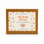 A rectangle kraft brown cardboard box for 'the wilde magnolia Big Brain Energy Kids Mini Aromatherapy Kit' with a colorful cartoon label on the front.