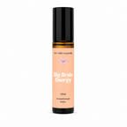 A 10ml aromatherapy roller bottle with a black cap and a peach-colored label. The label features the brand name 'the wilde magnolia' and the product name 'Big Brain Energy' in white text.