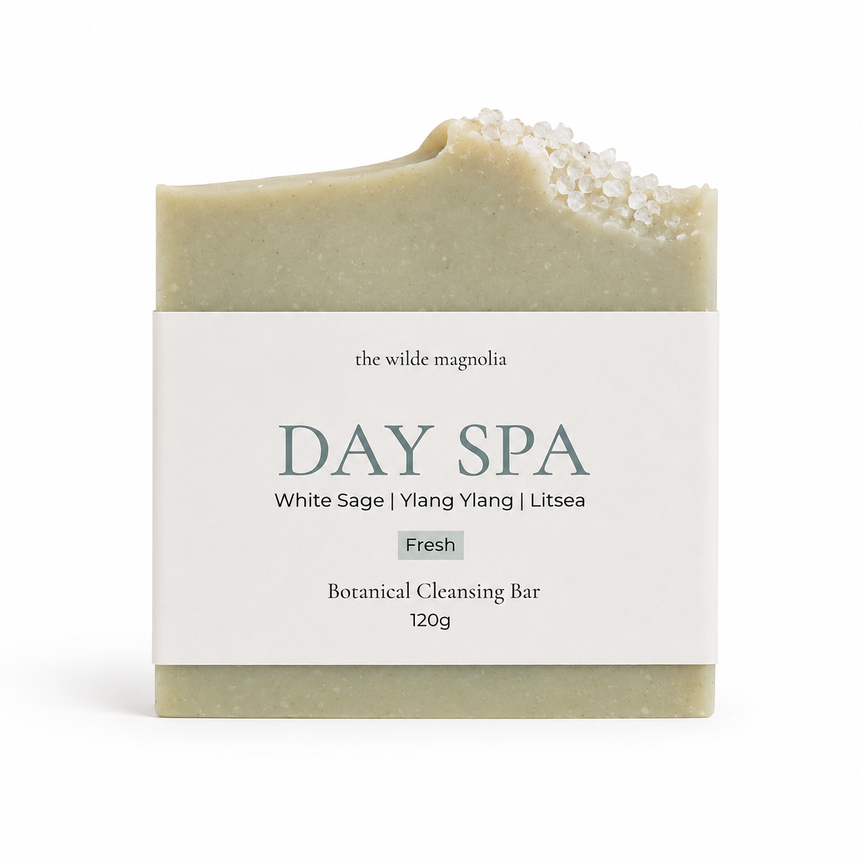 A single rectangular botanical cleansing bar wrapped in a white paper label reading 'the wilde magnolia DAY SPA White Sage | Ylang Ylang | Litsea Fresh Botanical Cleansing Bar 120g', photographed on a clean white background.
