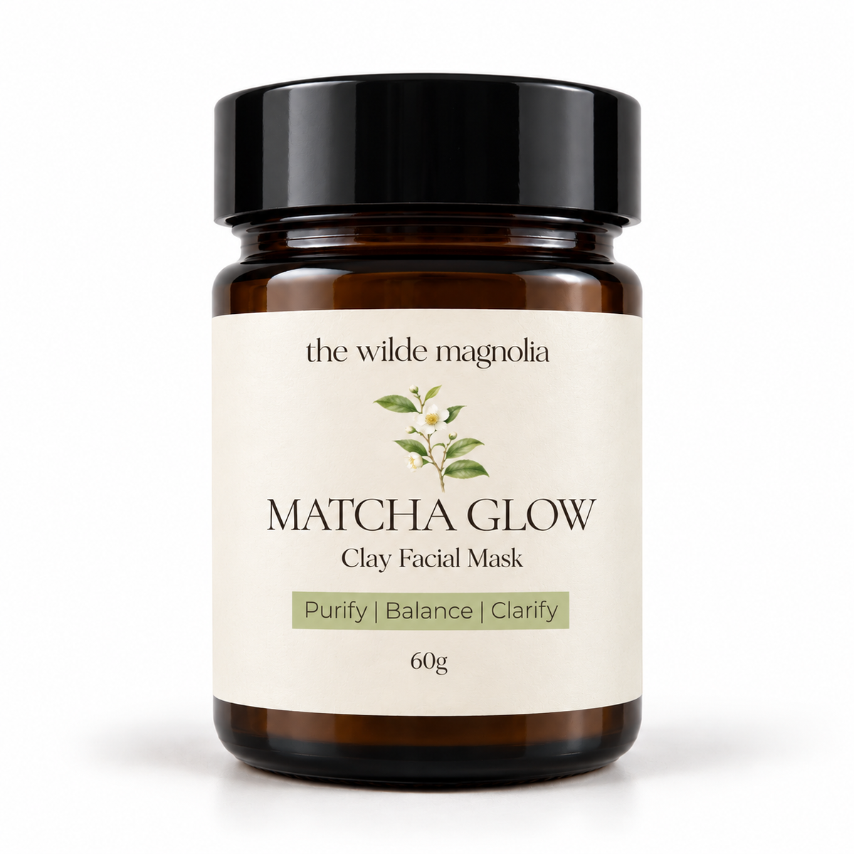 An amber glass jar on a white background with a label that reads Macha Glow Clay Facial Mask. Purify, Blance, Clarify