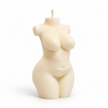 An ivory female torso candle shaped like a curvy female body, with a wick at the top, photographed on a clean white background.