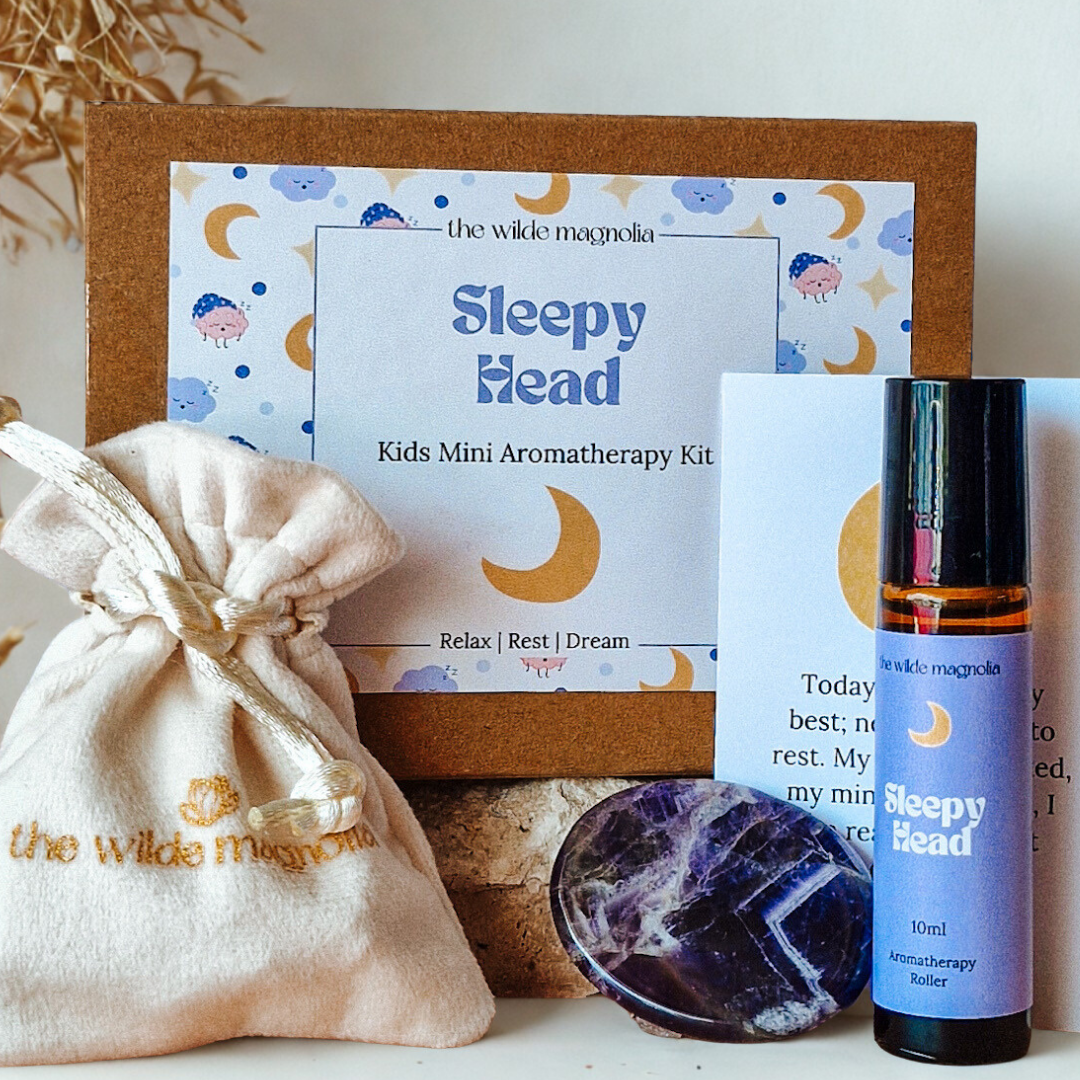 Kids Mini Aromatherapy Kit with 'Sleepy Head' label, including an essential oil roller bottle, pouch, affirmation card and amethyst stone palm stone.