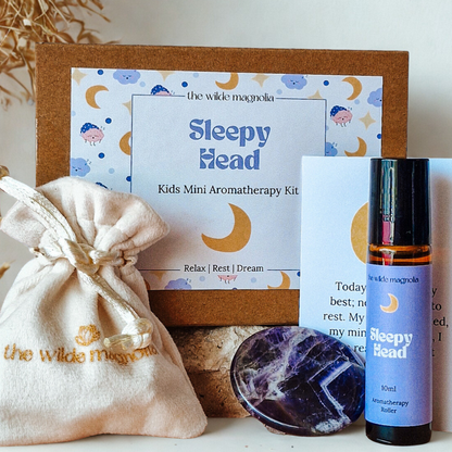 Kids Mini Aromatherapy Kit with 'Sleepy Head' label, including an essential oil roller bottle, pouch, affirmation card and amethyst stone palm stone.