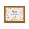 The Wilde Magnolia 'Sleepy Head' Kids Mini Aromatherapy Kit in its brown kraft paper box packaging, featuring a whimsical label with purple text and yellow crescent moons on a white background.