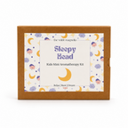The Wilde Magnolia 'Sleepy Head' Kids Mini Aromatherapy Kit in its brown kraft paper box packaging, featuring a whimsical label with purple text and yellow crescent moons on a white background.