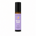 A 10ml roll-on bottle of 'Sleepy Head' aromatherapy oil by 'the wilde magnolia'. The product features a  purple blue label with a yellow crescent moon graphic and white text, housed in an amber glass bottle with a black cap, set against a plain white background.