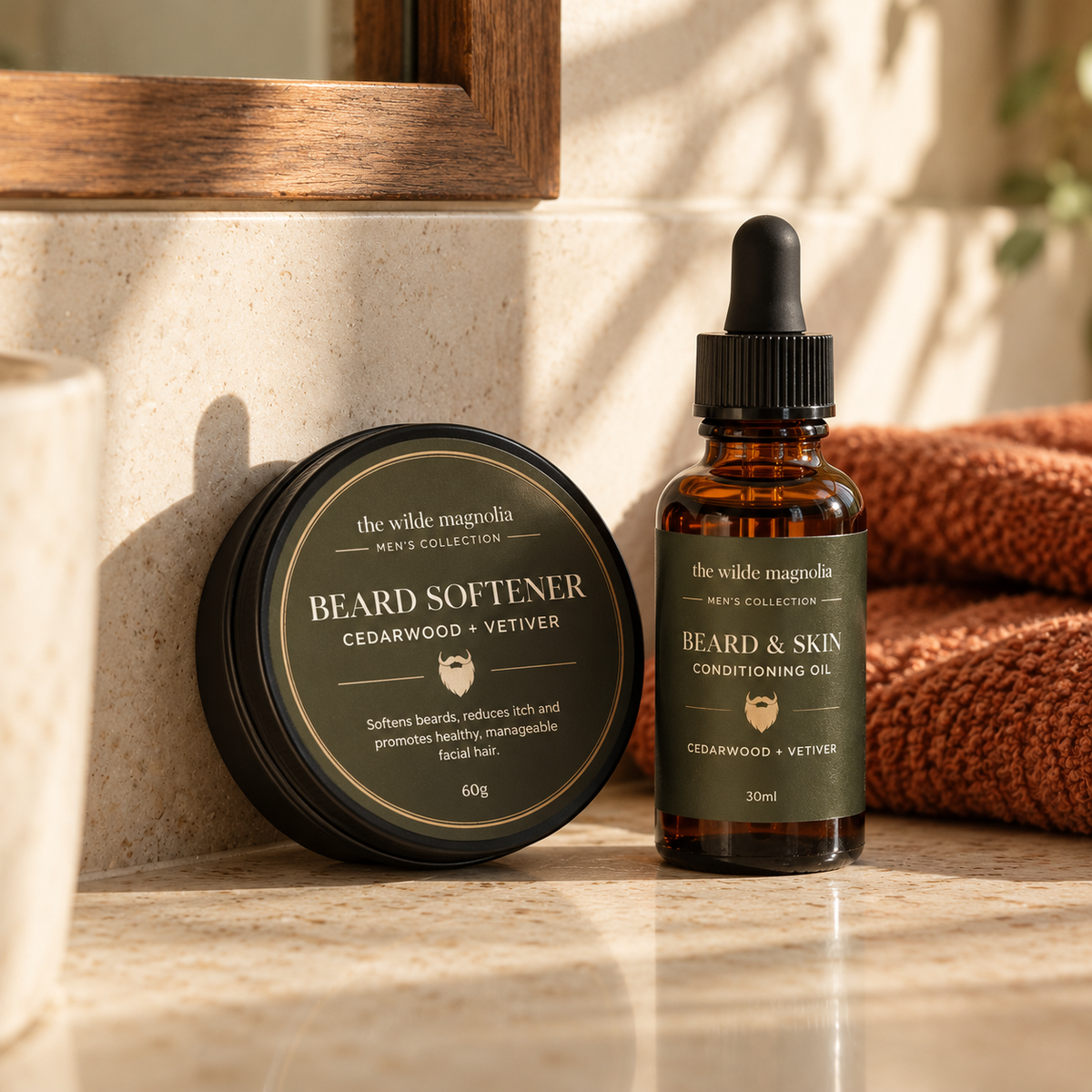 Bearn and skin conditioning oil bottle next to Beard softener tin on a warmly lit bathroom bench